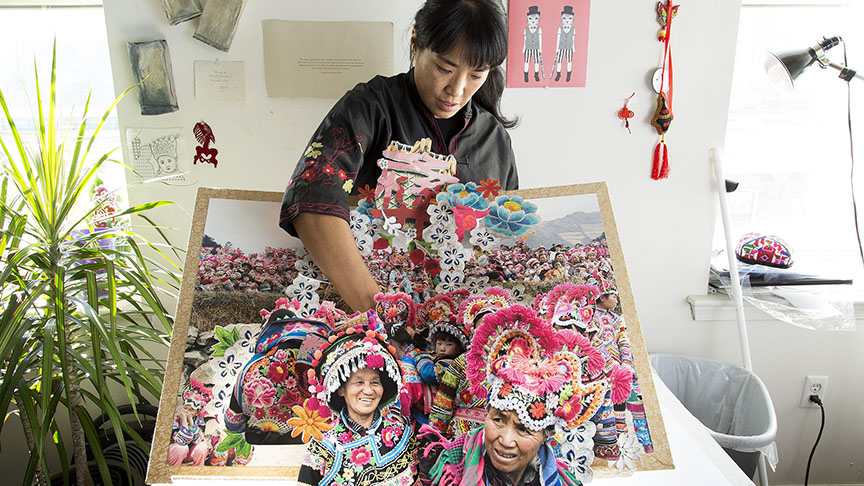 Colette Fu has spent decades researching and documenting the lives of China's ethnic minorities, publishing in the form of beautiful, intricate, hand-cut paper pop-up books. Fu works in her studio in Philadelphia, PA, on Tuesday, November 11, 2014. (photo by Laurence Kesterson)