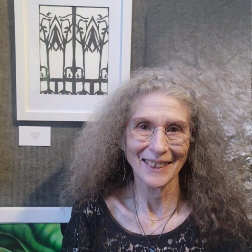 Donna with Avian Arbor papercutting at Anderson Art Exhibit